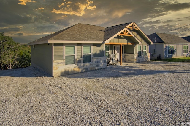 1139 Cedar Bnd, Canyon Lake, TX 78133 - view of front of home with board and batten siding, stone siding, and a shingled roof
