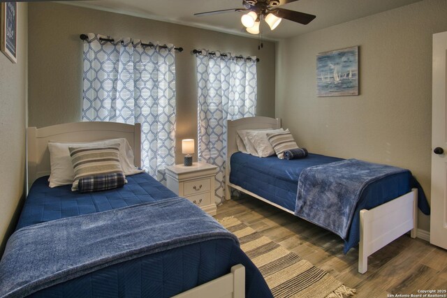 1139 Cedar Bnd, Canyon Lake, TX 78133 - bedroom with light wood-type flooring and ceiling fan