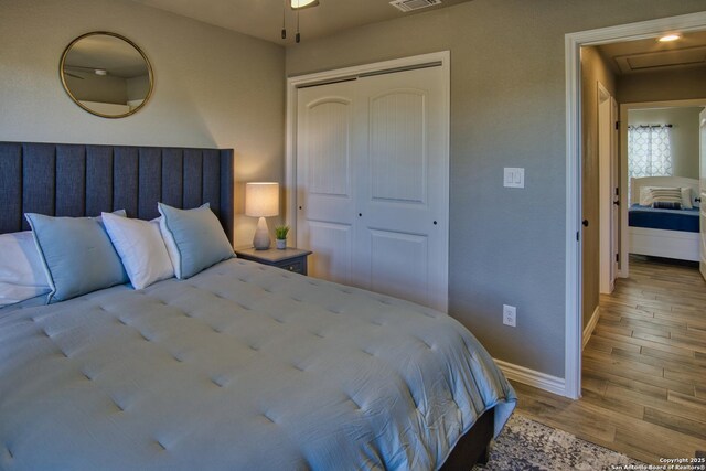 1139 Cedar Bnd, Canyon Lake, TX 78133 - bedroom with wood finished floors, baseboards, and a closet