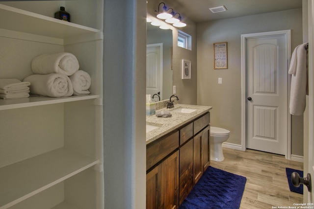 1139 Cedar Bnd, Canyon Lake, TX 78133 - full bath featuring wood finished floors, double vanity, and toilet