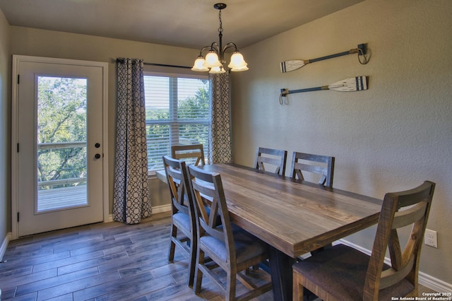 1139 Cedar Bnd, Canyon Lake, TX 78133 - dining area featuring a chandelier, wood finished floors, and baseboards
