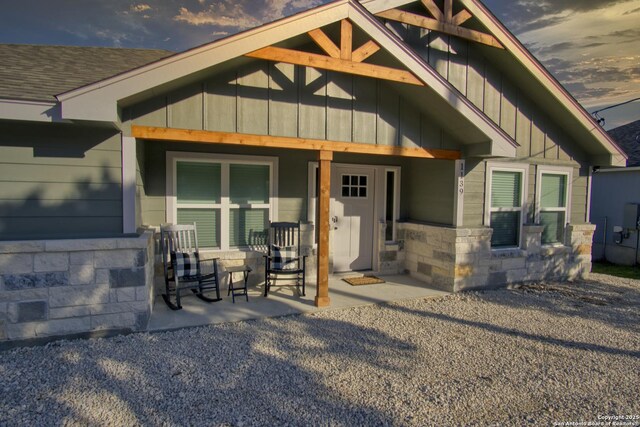 1139 Cedar Bnd, Canyon Lake, TX 78133 - back of house with board and batten siding and stone siding
