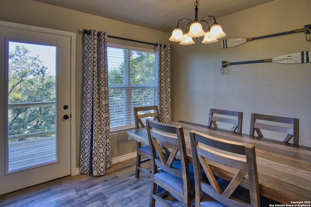 1139 Cedar Bnd, Canyon Lake, TX 78133 - dining room featuring a chandelier, wood finished floors, and baseboards