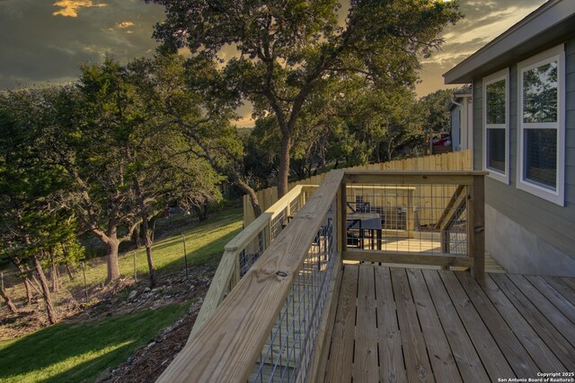 1139 Cedar Bnd, Canyon Lake, TX 78133 - deck at dusk featuring view of wooded area
