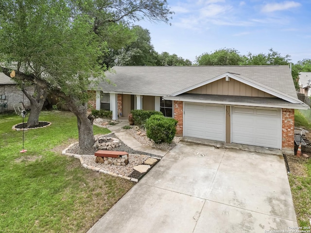 single story home with brick siding, concrete driveway, a garage, and a front yard