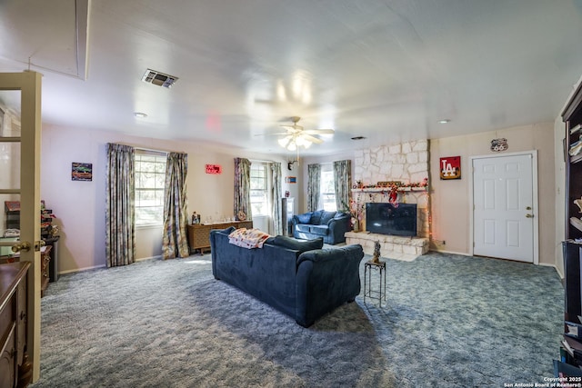 10180 Aliann, Atascosa, TX 78002 - living room with attic access, carpet, a stone fireplace, and ceiling fan