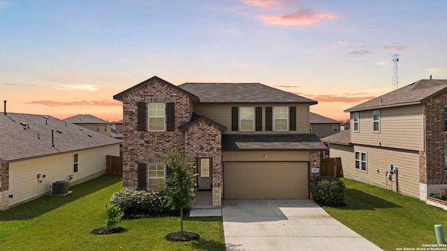 traditional-style house featuring a garage, concrete driveway, brick siding, a shingled roof, and central AC unit