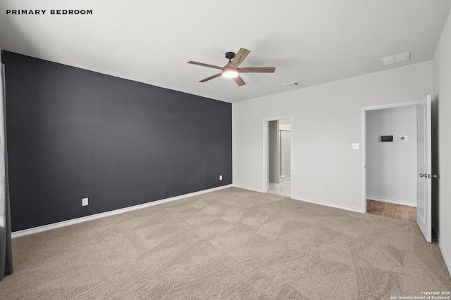 unfurnished bedroom featuring carpet floors, baseboards, and a ceiling fan