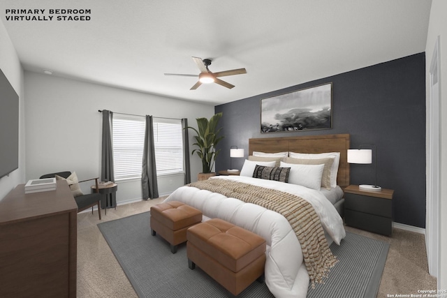 carpeted bedroom with ceiling fan and baseboards