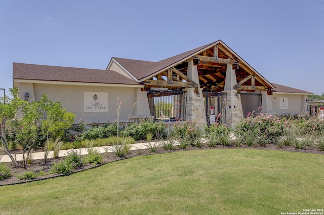 view of front of home with a front lawn and stucco siding