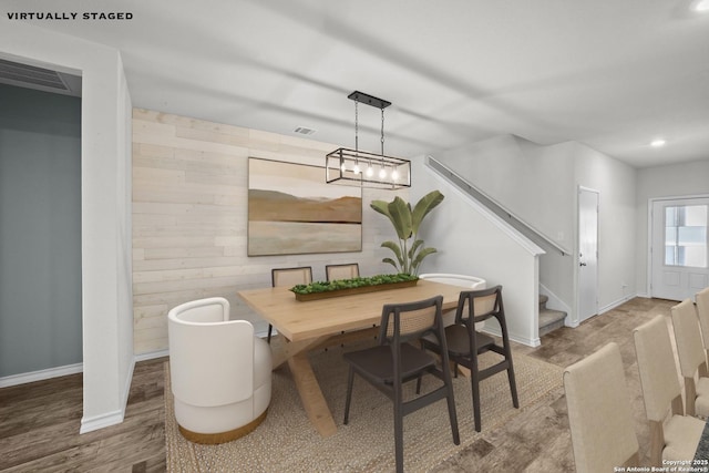 dining area with stairs, wood walls, wood finished floors, baseboards, and recessed lighting