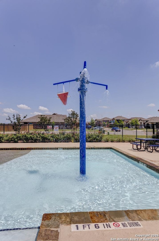 view of home's community with fence