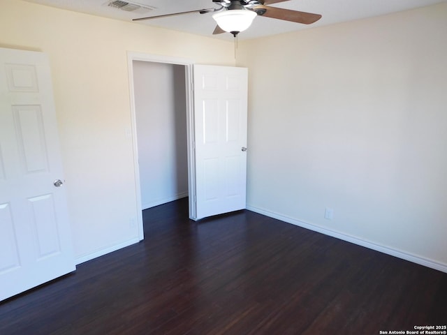 8918 Kenton Mist, San Antonio, TX 78240 - unfurnished bedroom featuring dark wood-style floors, baseboards, a closet, and ceiling fan
