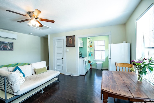 243 N, San Antonio, TX 78201 - living room with a wall mounted air conditioner, ceiling fan, dark wood-style flooring, and baseboards