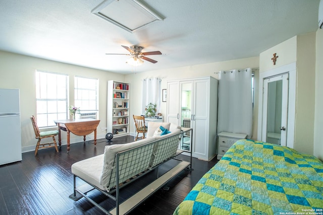 243 N, San Antonio, TX 78201 - bedroom featuring freestanding refrigerator, baseboards, dark wood-style floors, attic access, and a textured ceiling