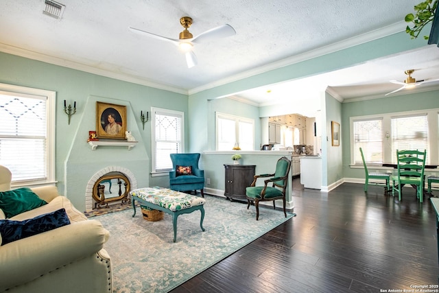 243 N, San Antonio, TX 78201 - living area with a ceiling fan, baseboards, healthy amount of natural light, dark wood finished floors, and crown molding