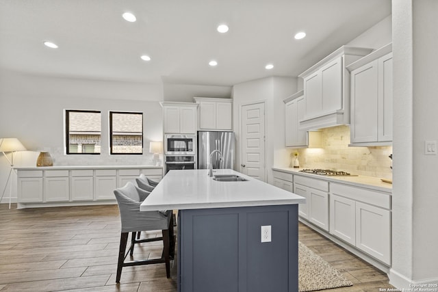 435 Bridle Trl, New Braunfels, TX 78132 - kitchen featuring appliances with stainless steel finishes, a sink, white cabinets, recessed lighting, and light countertops