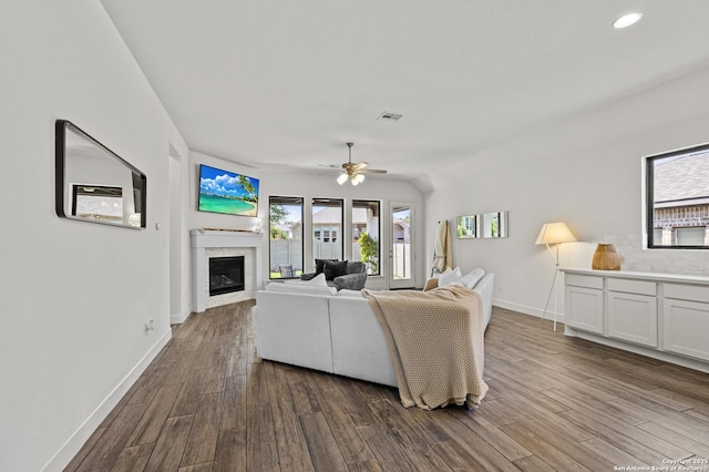 435 Bridle Trl, New Braunfels, TX 78132 - living room featuring dark wood finished floors, a glass covered fireplace, baseboards, ceiling fan, and recessed lighting