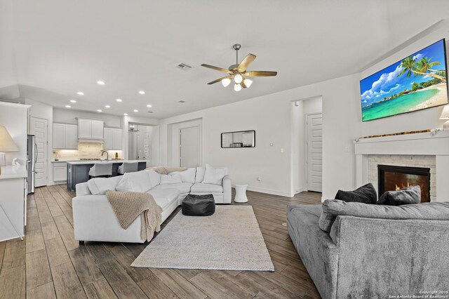 435 Bridle Trl, New Braunfels, TX 78132 - living area with recessed lighting, a ceiling fan, wood finished floors, a brick fireplace, and baseboards