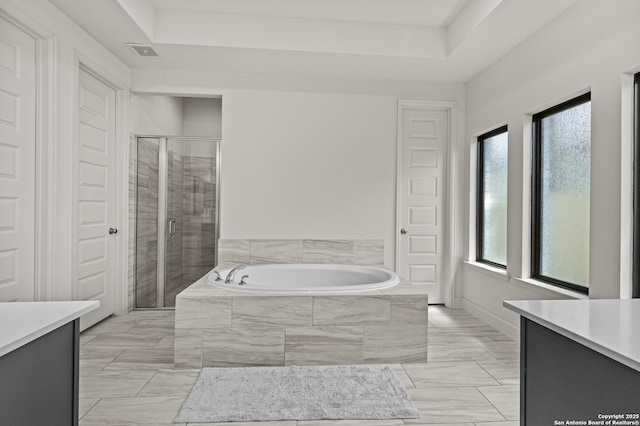 435 Bridle Trl, New Braunfels, TX 78132 - bathroom with vanity, a garden tub, a stall shower, and a tray ceiling