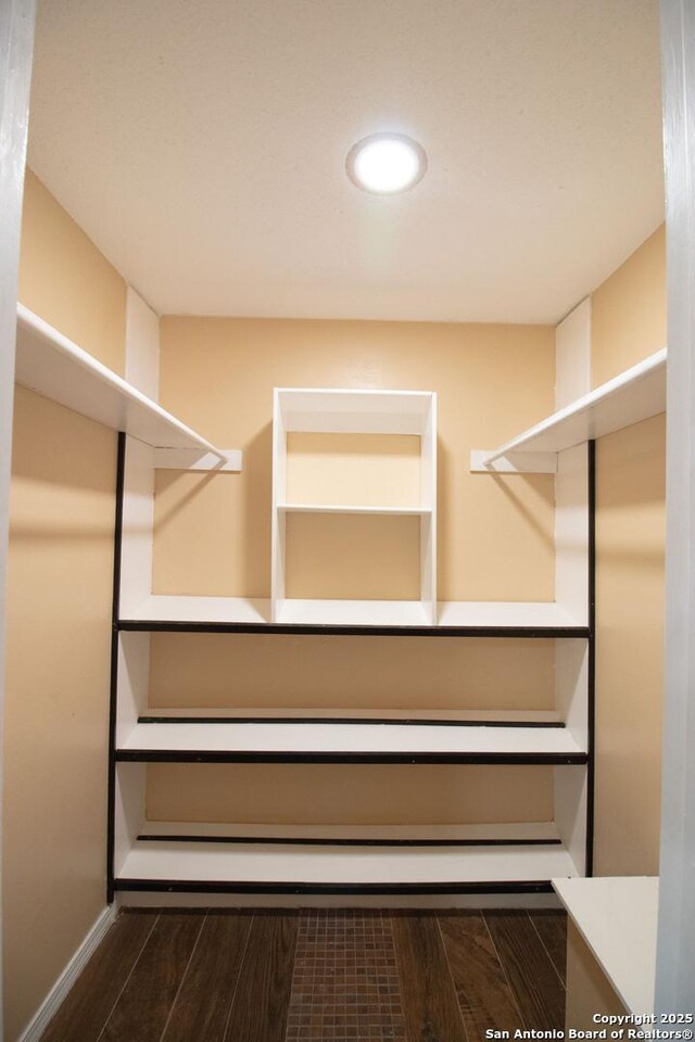 6614 Spring Hurst, San Antonio, TX 78249 - walk in closet with dark wood-type flooring