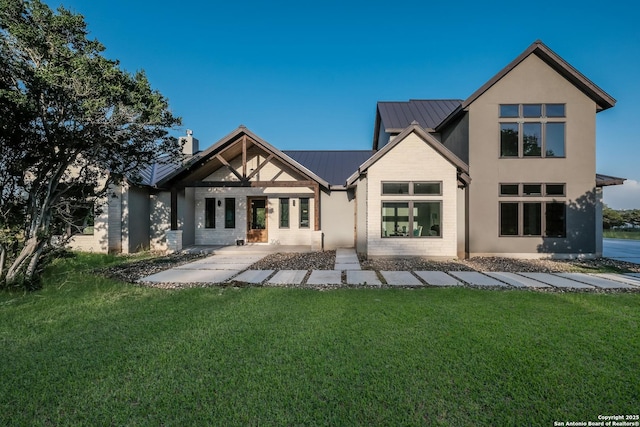 3045 Campestres, Spring Branch, TX 78070 - rear view of house featuring a lawn, metal roof, a chimney, and a standing seam roof