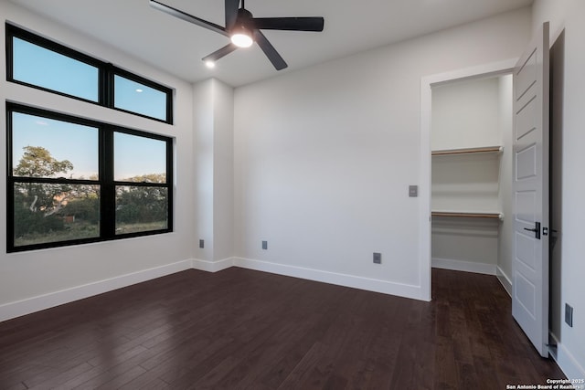 3045 Campestres, Spring Branch, TX 78070 - unfurnished bedroom with dark wood-style floors, baseboards, a walk in closet, and a ceiling fan
