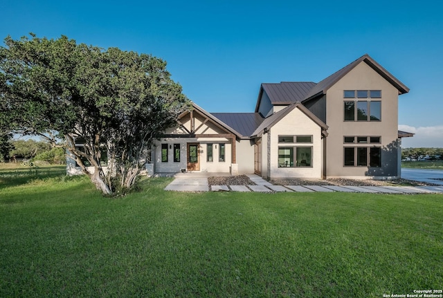 3045 Campestres, Spring Branch, TX 78070 - back of house with a yard, metal roof, stucco siding, and a standing seam roof