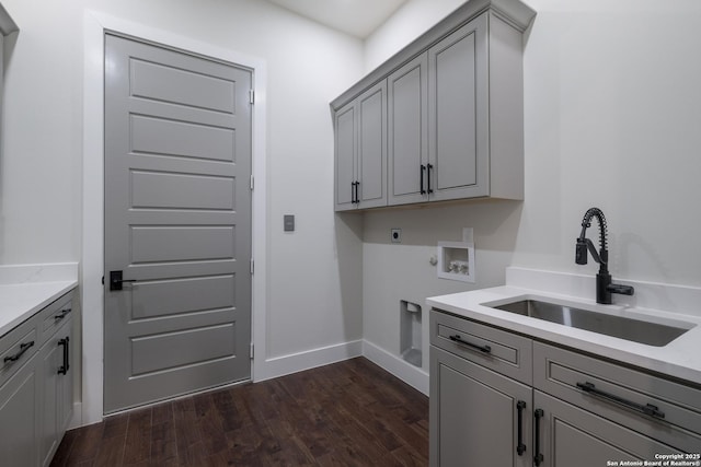 3045 Campestres, Spring Branch, TX 78070 - laundry area with electric dryer hookup, cabinet space, washer hookup, dark wood-style floors, and baseboards