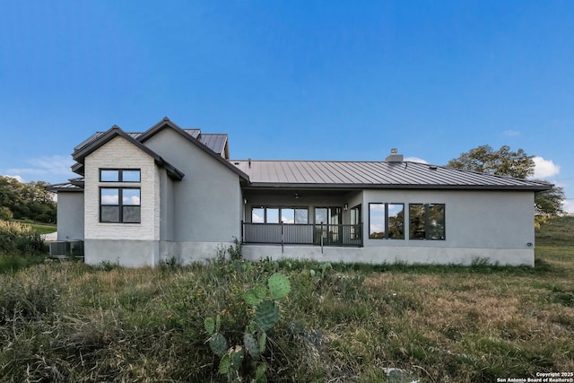 3045 Campestres, Spring Branch, TX 78070 - back of house with a standing seam roof, metal roof, stucco siding, and cooling unit