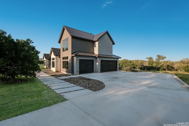 3045 Campestres, Spring Branch, TX 78070 - view of side of home featuring stucco siding, a standing seam roof, a garage, metal roof, and driveway