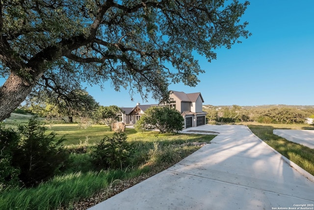 3045 Campestres, Spring Branch, TX 78070 - view of community featuring an attached garage, concrete driveway, and a yard