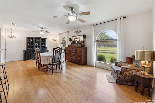 101 Cynthia, Pleasanton, TX 78064 - dining space featuring a chandelier, a ceiling fan, light wood-style flooring, and baseboards