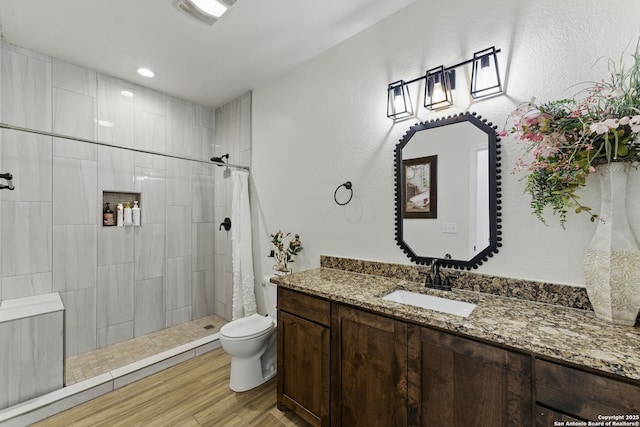 1110 Atascosa County Road 101, Floresville, TX 78114 - full bath with wood finished floors, tiled shower, toilet, vanity, and recessed lighting