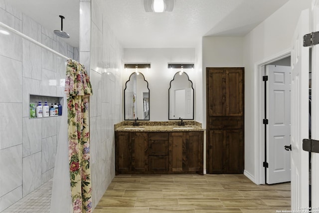1110 Atascosa County Road 101, Floresville, TX 78114 - bathroom featuring walk in shower, double vanity, and wood tiled floors