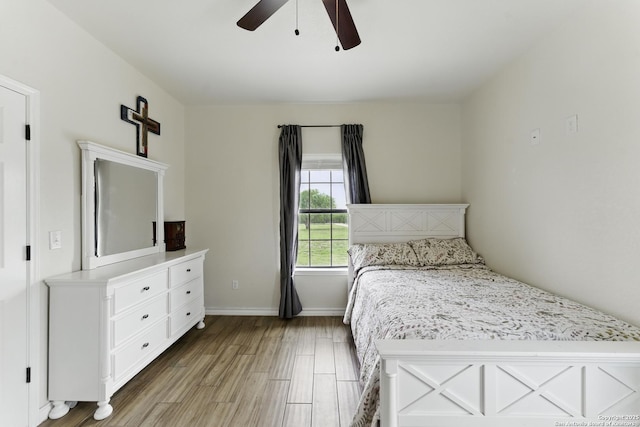 1110 Atascosa County Road 101, Floresville, TX 78114 - bedroom featuring wood finished floors, a ceiling fan, and baseboards