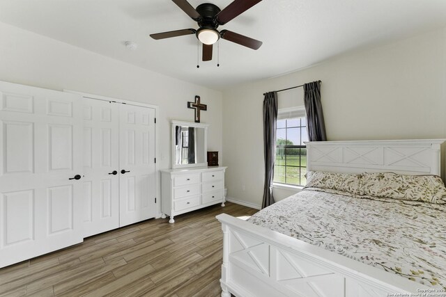 1110 Atascosa County Road 101, Floresville, TX 78114 - bedroom featuring wood finished floors, a closet, baseboards, and ceiling fan