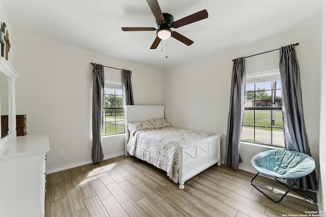 1110 Atascosa County Road 101, Floresville, TX 78114 - bedroom featuring light wood finished floors, baseboards, and a ceiling fan
