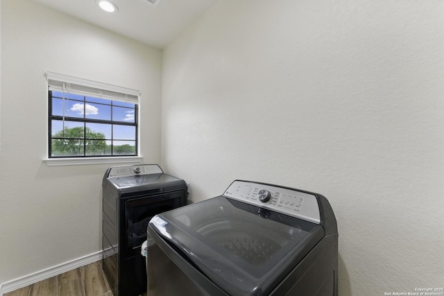 1110 Atascosa County Road 101, Floresville, TX 78114 - laundry area with wood finished floors, washing machine and clothes dryer, and baseboards