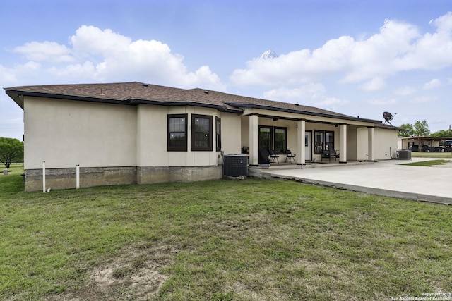 1110 Atascosa County Road 101, Floresville, TX 78114 - back of property featuring a ceiling fan, a patio, a yard, central AC, and stucco siding