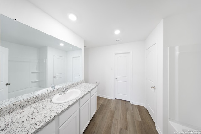 12056 Luckey Villa, San Antonio, TX 78252 - full bathroom featuring wood finished floors, vanity, recessed lighting, and baseboards