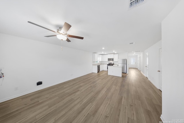 12056 Luckey Villa, San Antonio, TX 78252 - unfurnished living room with a ceiling fan, light wood-type flooring, recessed lighting, and baseboards