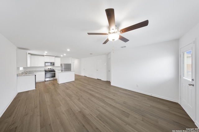 12056 Luckey Villa, San Antonio, TX 78252 - unfurnished living room featuring recessed lighting, a ceiling fan, baseboards, and dark wood-type flooring