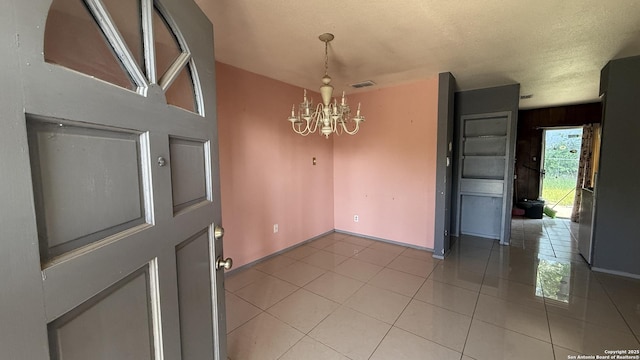 1906 Perlita, San Antonio, TX 78224 - unfurnished dining area with a chandelier, light tile patterned floors, and baseboards