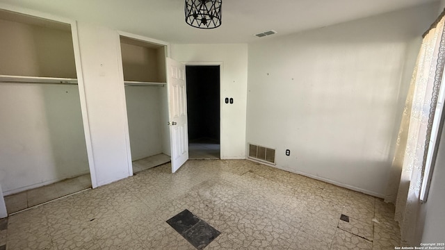 1906 Perlita, San Antonio, TX 78224 - unfurnished bedroom with multiple closets and tile patterned floors