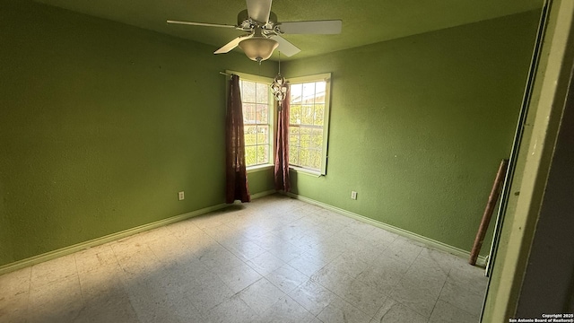 1906 Perlita, San Antonio, TX 78224 - spare room with a ceiling fan, baseboards, tile patterned floors, and a textured wall