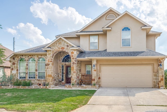 view of front of house featuring stone siding, driveway, a front yard, stucco siding, and a garage