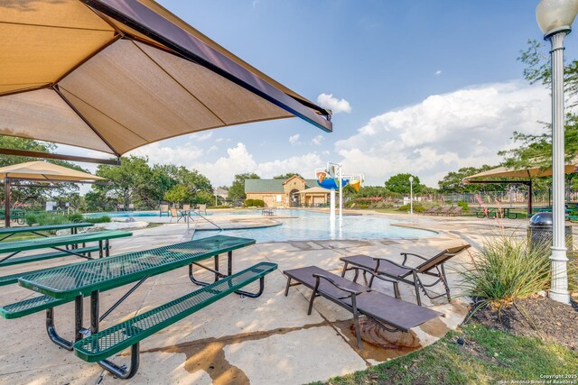 view of community with a pool and a patio