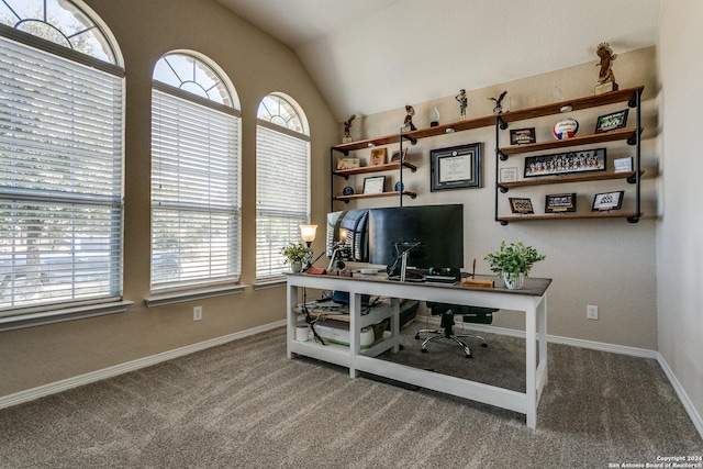 carpeted office featuring lofted ceiling and baseboards