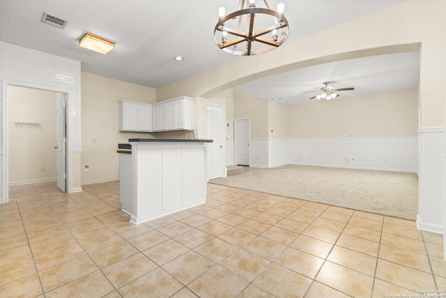 6739 Nora Vista Way, San Antonio, TX 78233 - kitchen with a chandelier, ceiling fan, dark countertops, light tile patterned floors, and white cabinets